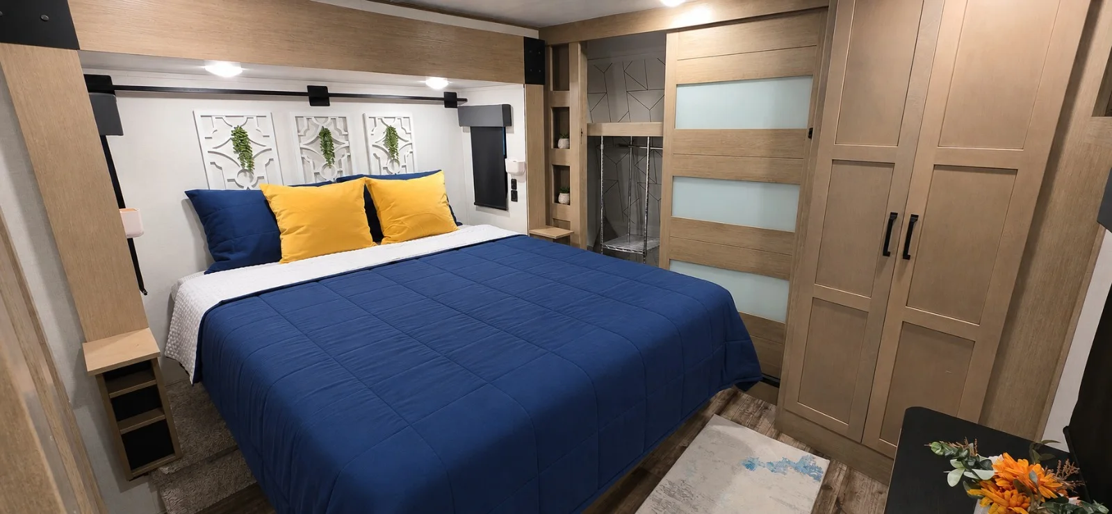 Bright private bedroom with a king bed, closing door, and built-in storage